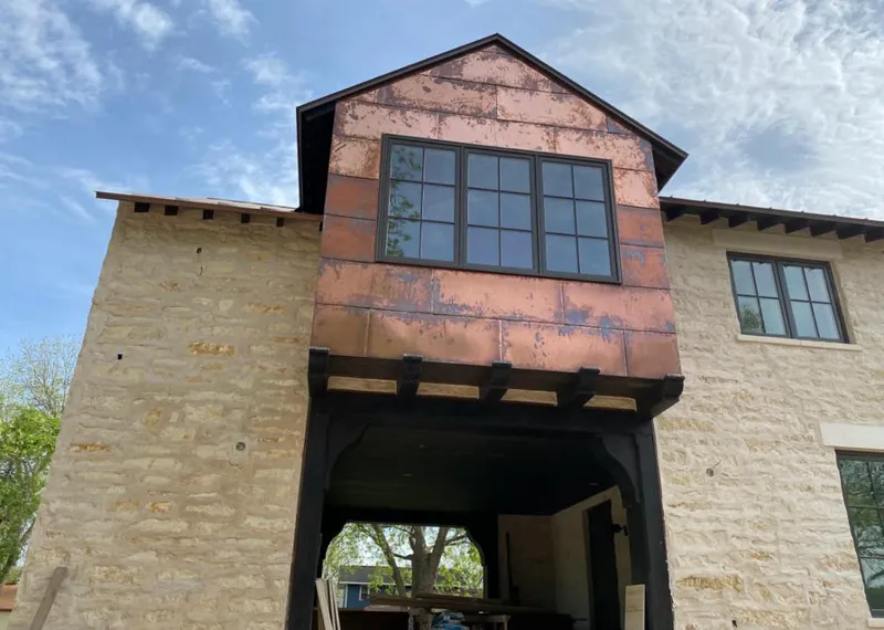 Copper metal panel facade on a stone building for Skylight Installation in Heeia
